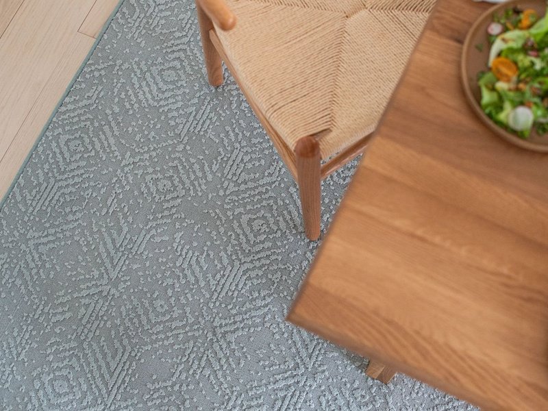 gray patterned rug and brown table